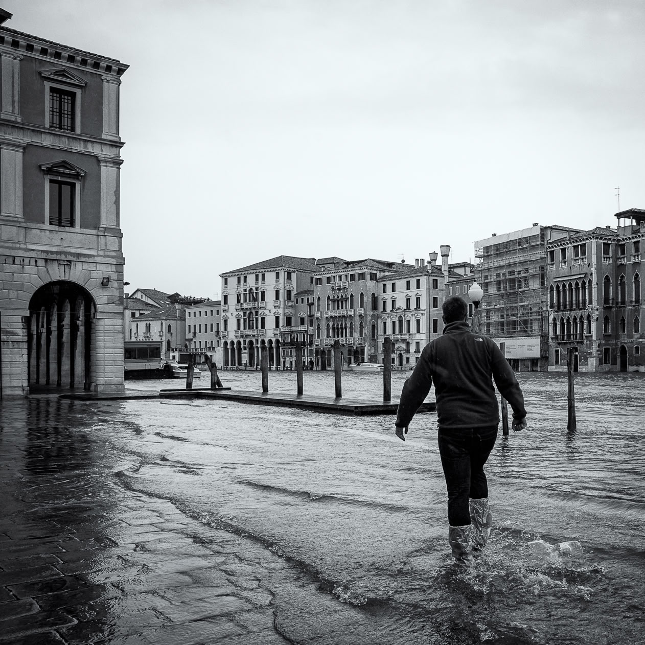 The author's self portrait.  A black and white image of him walking through a flooded Venice.